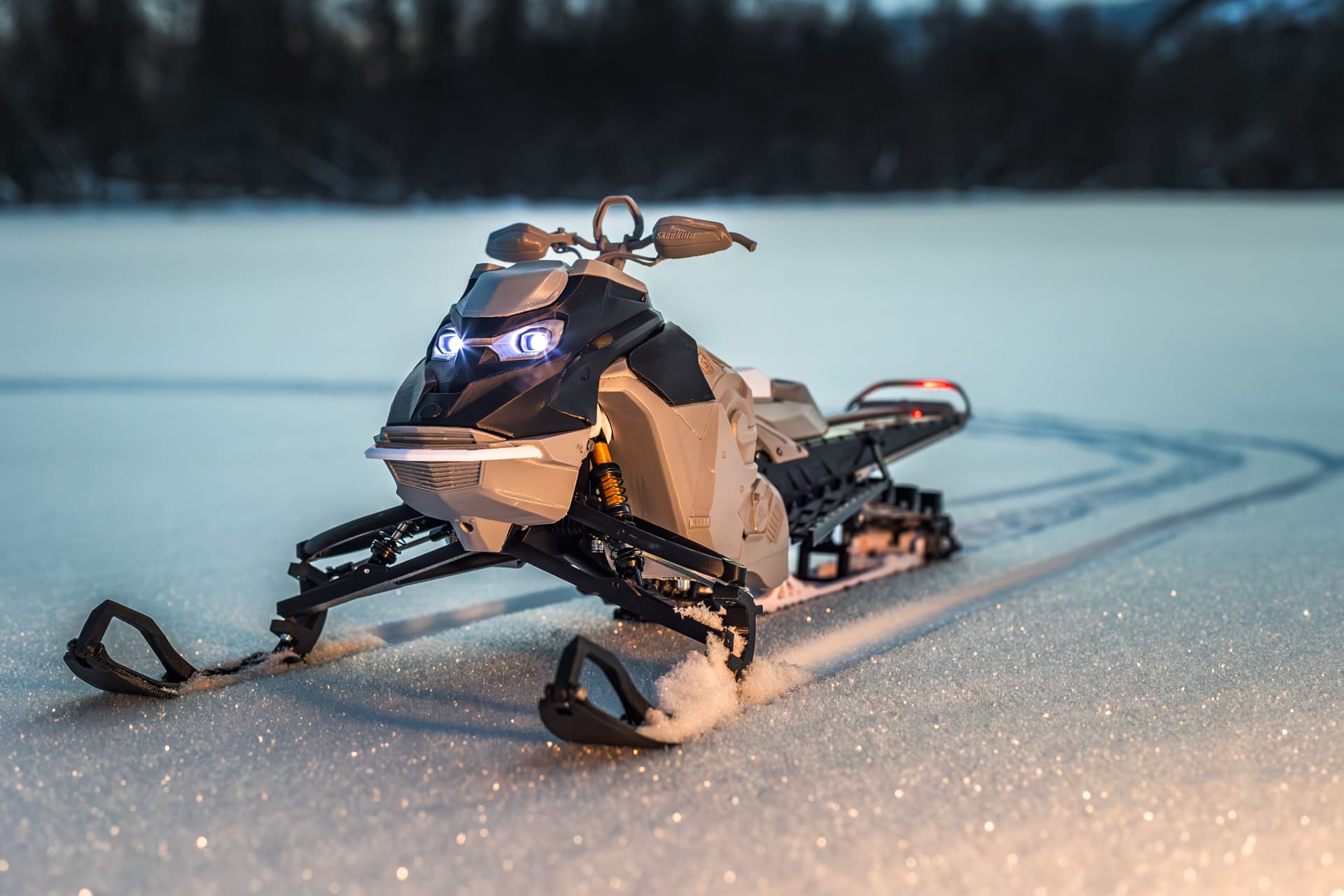 Large 1/5th scale RC snowmobile on a workbench